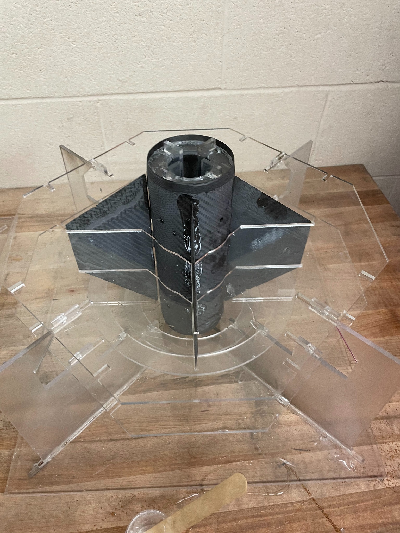 Carbon fiber rocket fin assembly held in clear fabrication fixture